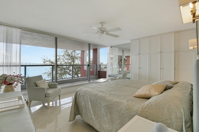 bedroom featuring expansive windows and light tile patterned flooring