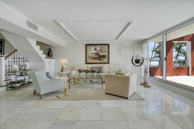 living room featuring visible vents and stairs