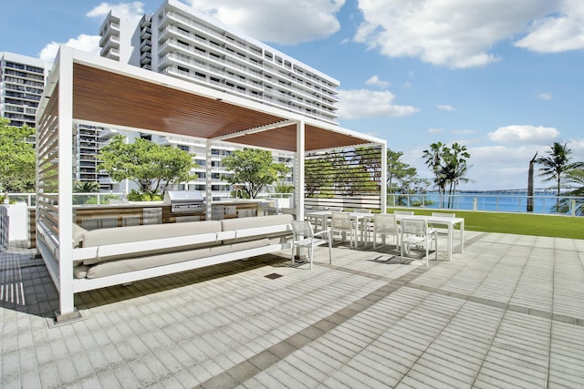 view of patio with a water view and area for grilling