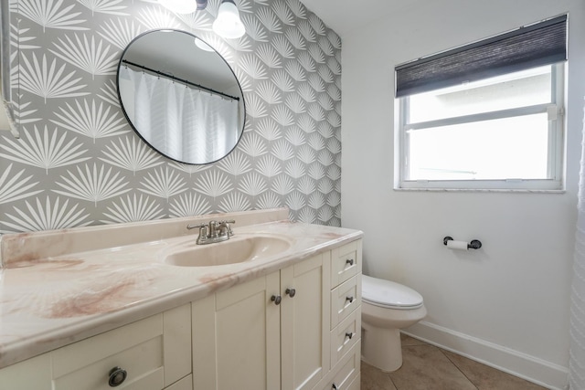 full bathroom with baseboards, vanity, toilet, and tile patterned floors