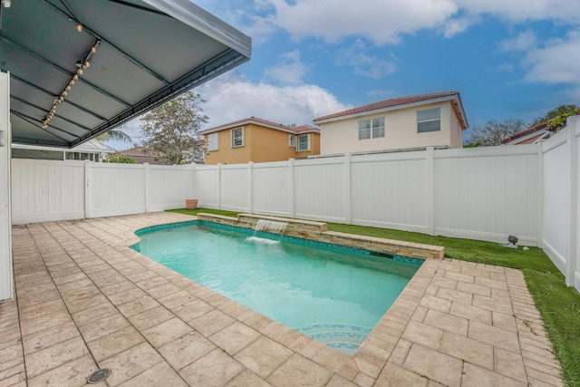 view of swimming pool featuring a patio area, a fenced backyard, and a fenced in pool