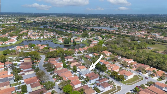 birds eye view of property featuring a water view and a residential view