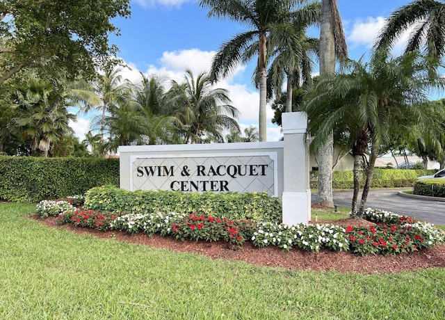 community sign featuring a lawn