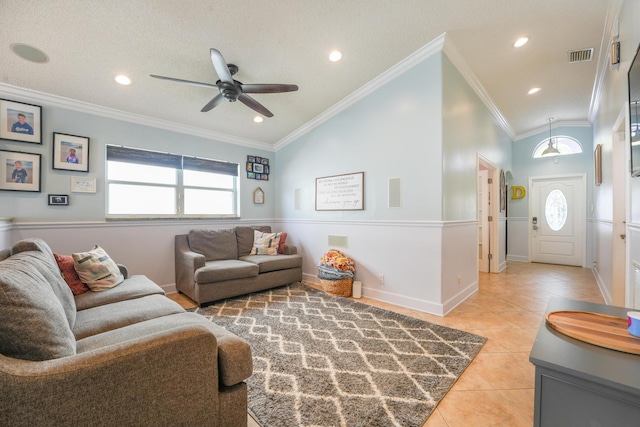 living room with light tile patterned floors, plenty of natural light, visible vents, and crown molding