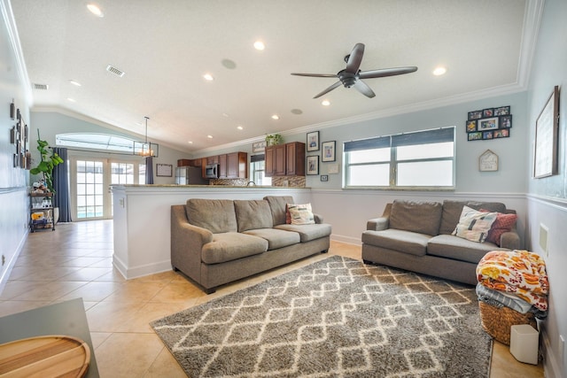 living area featuring vaulted ceiling, light tile patterned flooring, crown molding, and visible vents