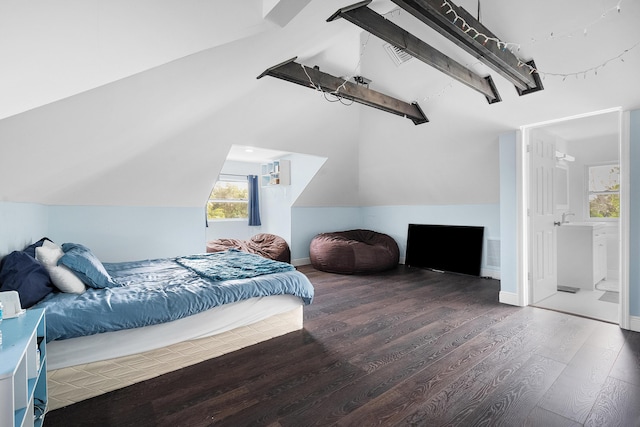 bedroom featuring vaulted ceiling with beams, wood finished floors, visible vents, and baseboards