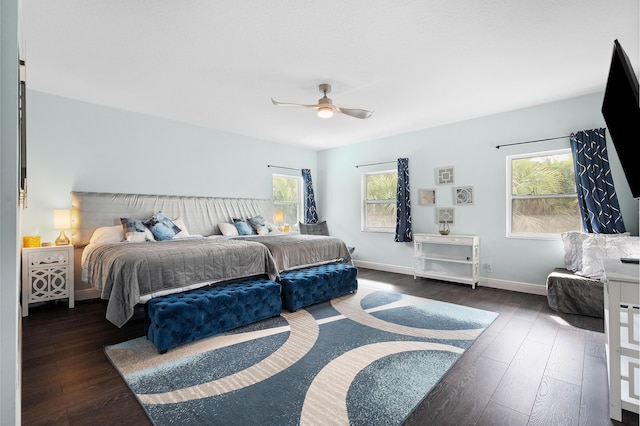 bedroom featuring dark wood-style floors, baseboards, and a ceiling fan