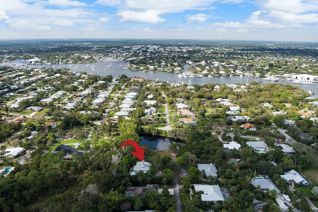 drone / aerial view featuring a water view and a residential view