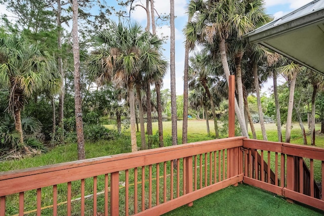 wooden terrace with a lawn