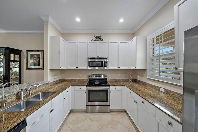 kitchen featuring appliances with stainless steel finishes, dark stone counters, light tile patterned flooring, and a sink