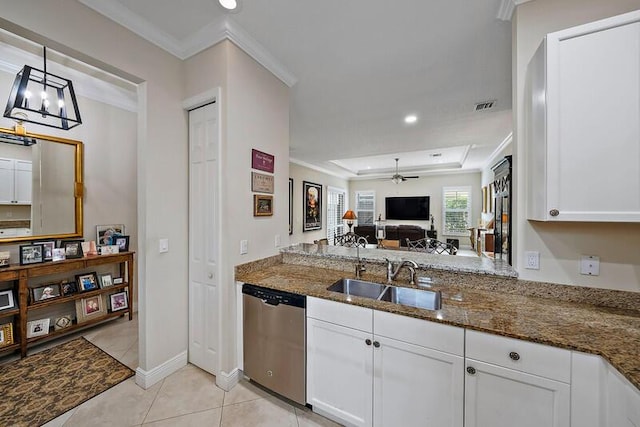 kitchen featuring crown molding, white cabinetry, a sink, dark stone counters, and dishwasher