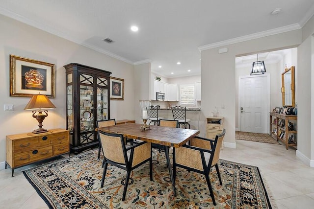 dining room featuring crown molding, light tile patterned floors, recessed lighting, visible vents, and baseboards