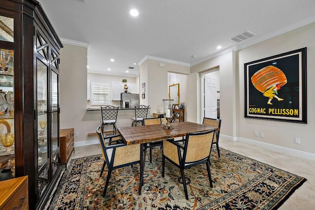 dining room with ornamental molding, recessed lighting, visible vents, and baseboards