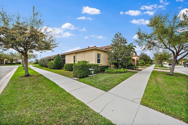 view of side of home featuring a lawn and stucco siding