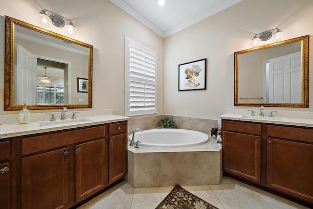 bathroom with crown molding, two vanities, a garden tub, and a sink