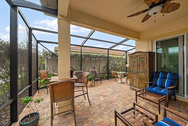 view of patio / terrace featuring a ceiling fan and a lanai