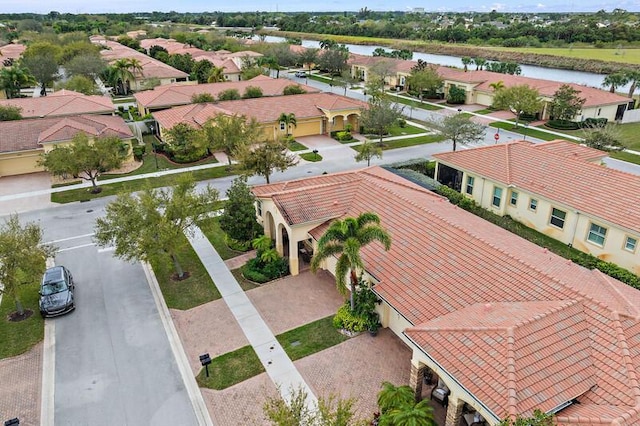 drone / aerial view featuring a water view and a residential view