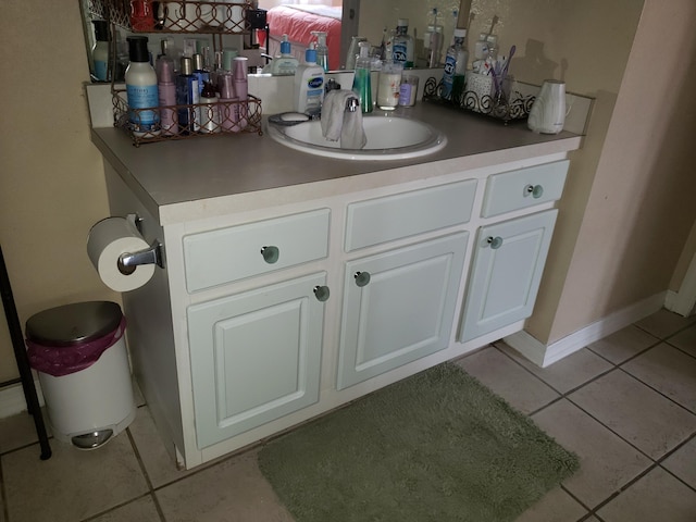 bathroom featuring tile patterned flooring, vanity, and baseboards