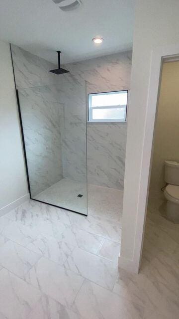 full bathroom with a walk in shower, toilet, recessed lighting, baseboards, and marble finish floor