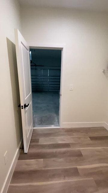 empty room with wood finished floors and baseboards