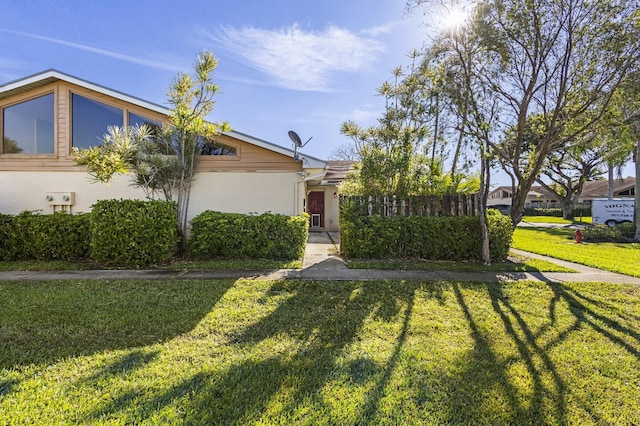 view of front facade with a front lawn and stucco siding