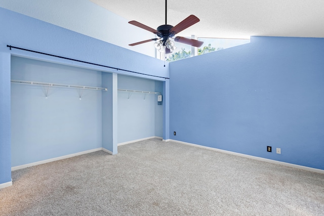 unfurnished bedroom featuring lofted ceiling, carpet, baseboards, and a closet