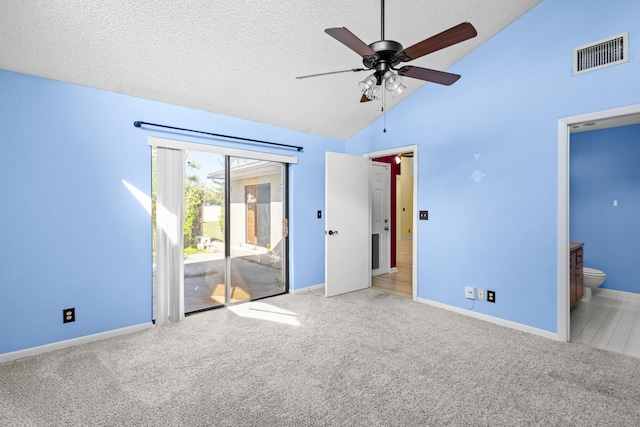 unfurnished bedroom featuring carpet floors, access to exterior, visible vents, and a textured ceiling