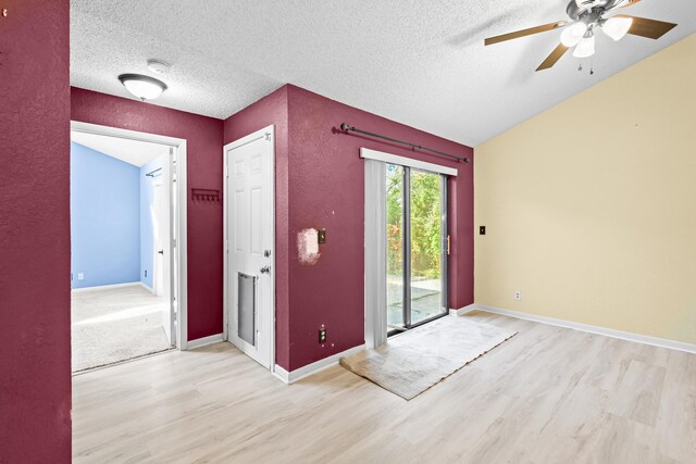 empty room featuring baseboards, visible vents, light wood-style flooring, ceiling fan, and a textured ceiling