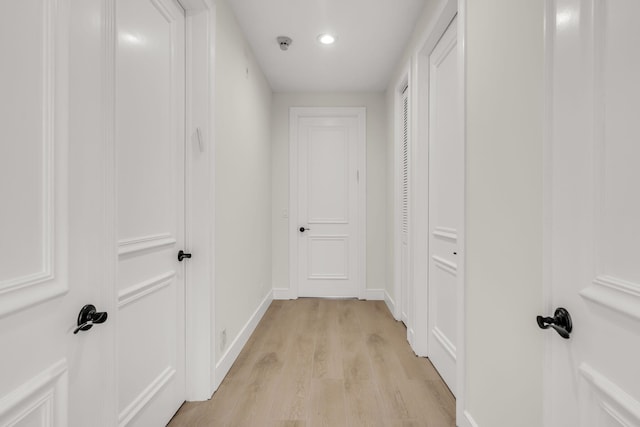 hall featuring recessed lighting, light wood-style floors, and baseboards