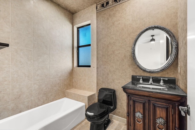 full bath with tile patterned floors, toilet, vanity, and a tub to relax in
