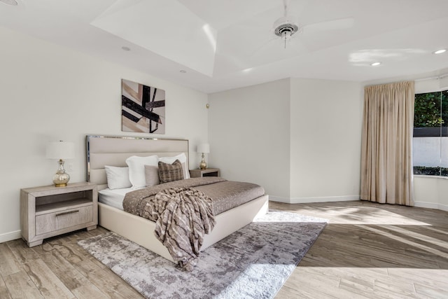 bedroom featuring recessed lighting, baseboards, wood finished floors, and a ceiling fan