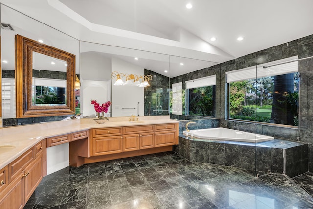 full bath with a bath, visible vents, vanity, and vaulted ceiling