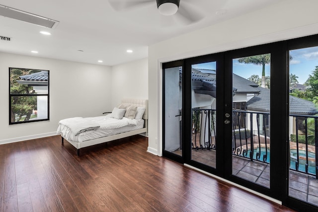bedroom featuring recessed lighting, wood-type flooring, baseboards, and access to outside