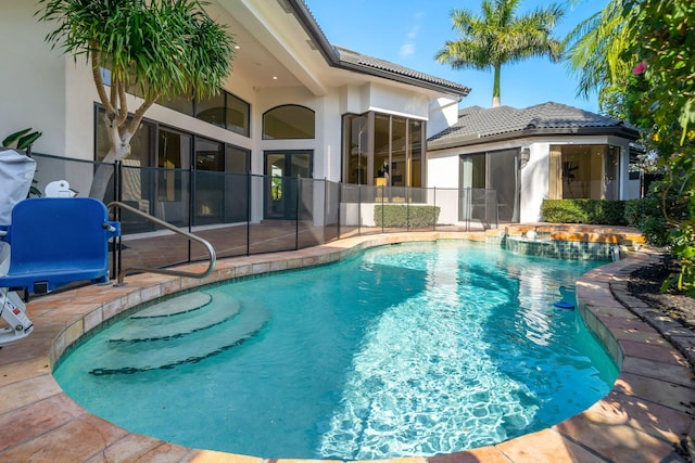 view of swimming pool with a patio and a pool with connected hot tub