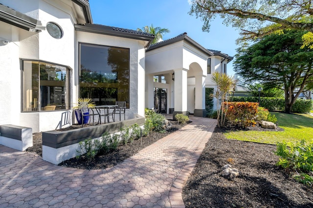 doorway to property with stucco siding