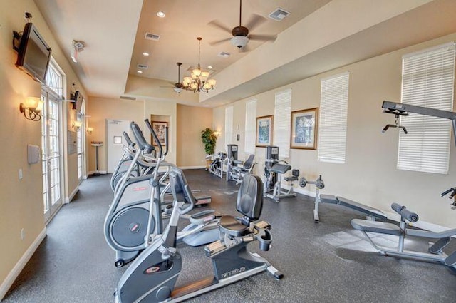 exercise room featuring recessed lighting, a raised ceiling, visible vents, and baseboards