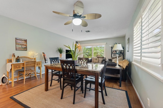 dining space with baseboards, ceiling fan, visible vents, and light wood-style floors