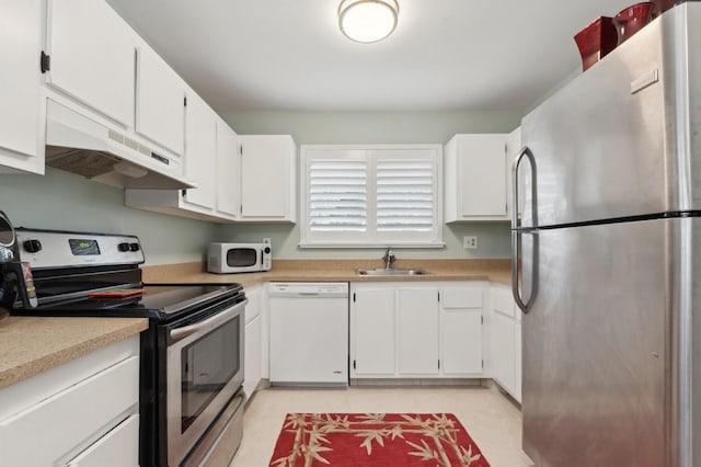 kitchen featuring stainless steel appliances, a sink, light countertops, and under cabinet range hood