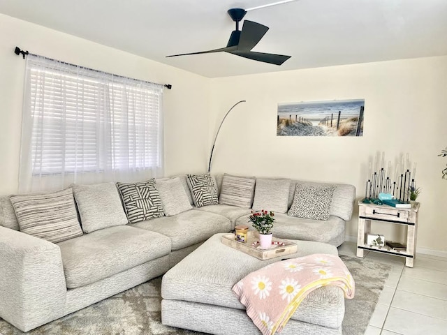 living room featuring light tile patterned floors, ceiling fan, and baseboards