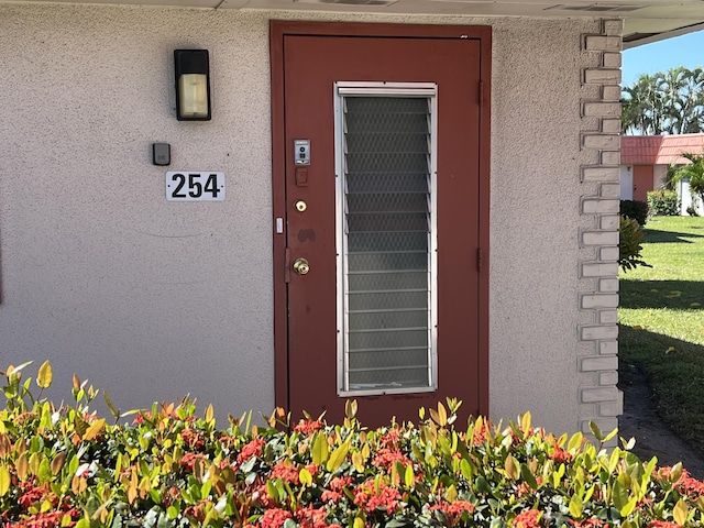 doorway to property with stucco siding