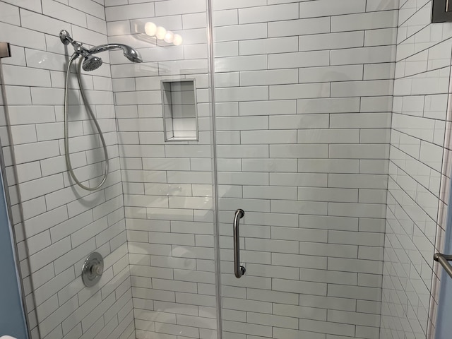 bathroom featuring a shower stall