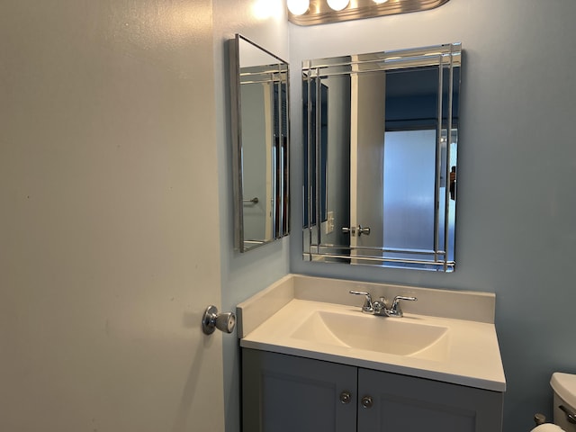 bathroom featuring toilet and vanity