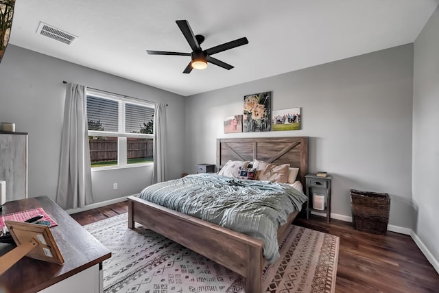 bedroom featuring visible vents, ceiling fan, baseboards, and wood finished floors