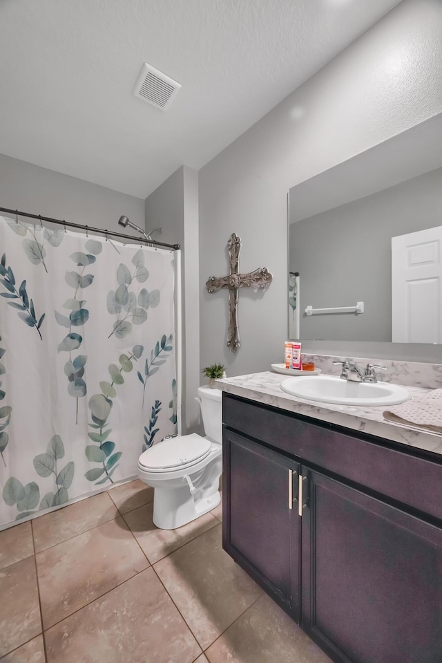 bathroom with toilet, tile patterned floors, vanity, visible vents, and a shower with curtain