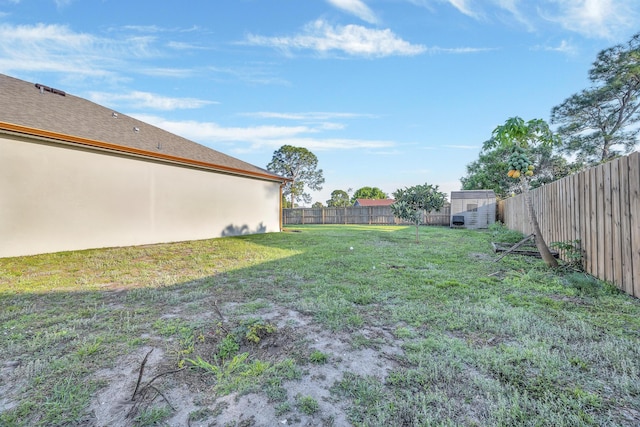 view of yard with an outbuilding and a fenced backyard