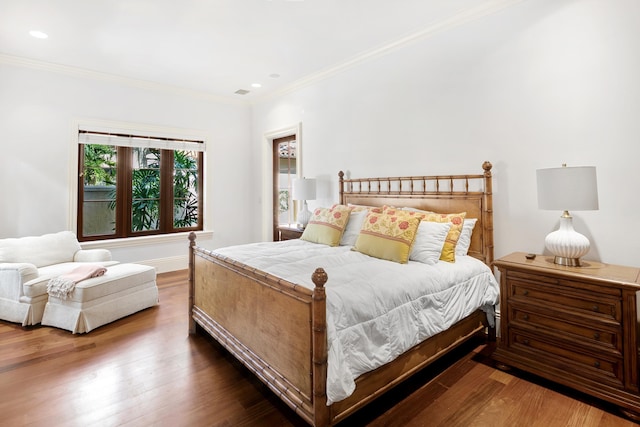 bedroom with baseboards, ornamental molding, wood finished floors, and recessed lighting