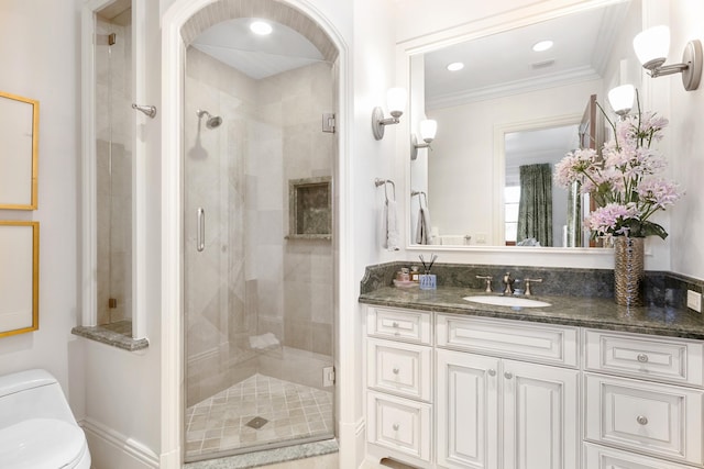 bathroom featuring crown molding, recessed lighting, toilet, a shower stall, and vanity