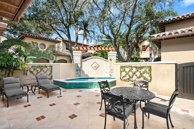 view of patio / terrace with outdoor dining area, fence, and an outdoor pool