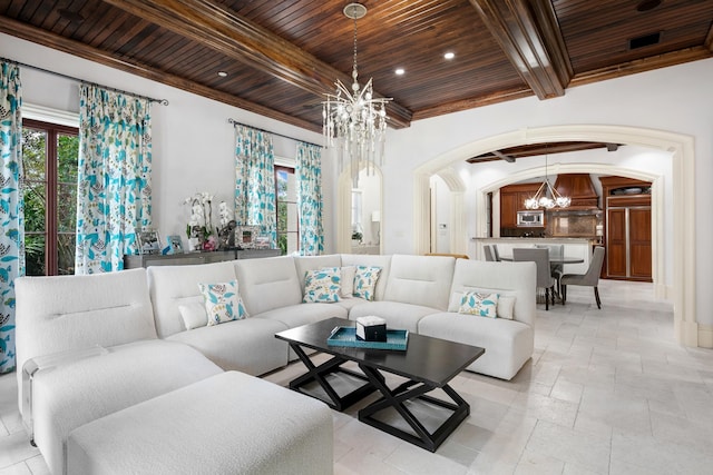 living room with a chandelier, wooden ceiling, arched walkways, and a wealth of natural light