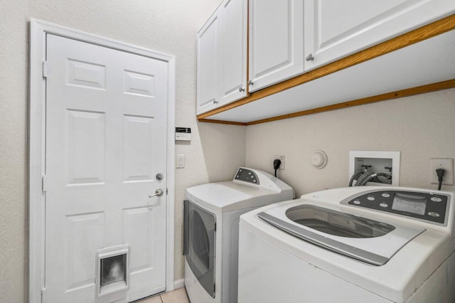 laundry area featuring cabinet space and separate washer and dryer